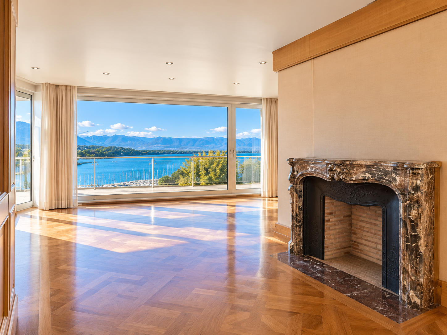 Geneva duplex penthouse — salon with dark marble fireplace and Lake Geneva views