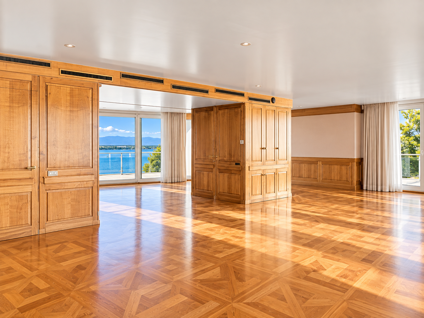 Geneva duplex penthouse — wood-panelled room with lake views