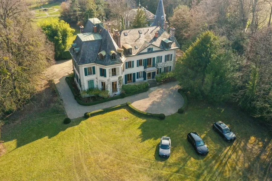 Historic Geneva estate Choulex — aerial view of the manor and wooded grounds with mature trees