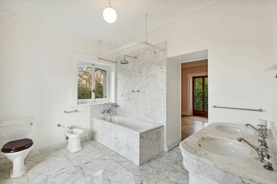 Historic Geneva estate Choulex — principal bathroom with full Carrara marble walls, floors and bath surround