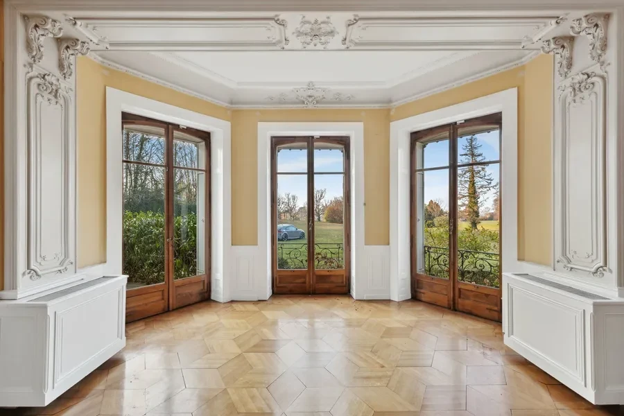 Historic Geneva estate Choulex — grand salon with period stucco mouldings, herringbone parquet and French doors to grounds