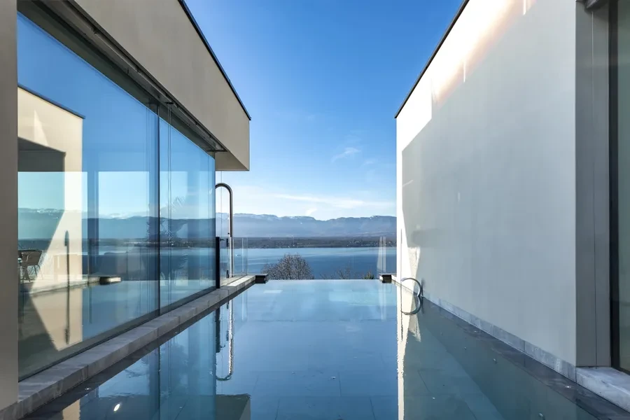 Cologny Geneva contemporary villa — infinity pool with panoramic views over Lake Geneva and the Alps