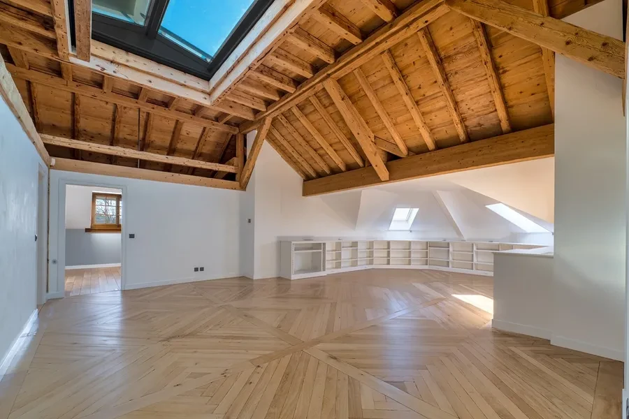 Cologny Geneva historic manor estate — attic level with exposed original timber beams, skylights and herringbone parquet