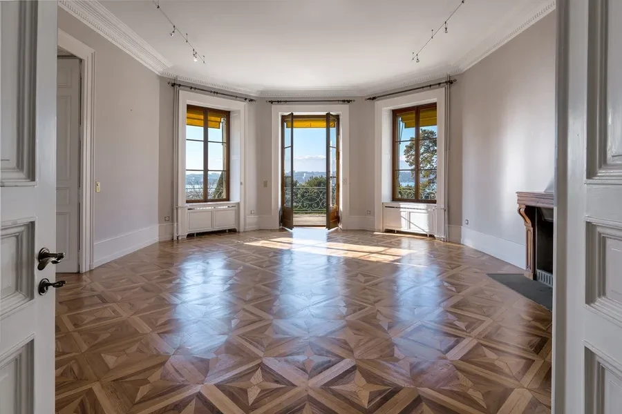 Cologny Geneva historic manor estate — grand salon with marquetry parquet floors, French doors and panoramic lake views