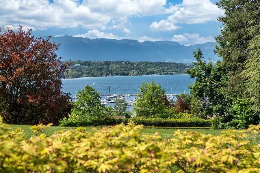 Domaine de Port-Noir Cologny Geneva — view from the private gardens over Lake Geneva marina and the surrounding mountains