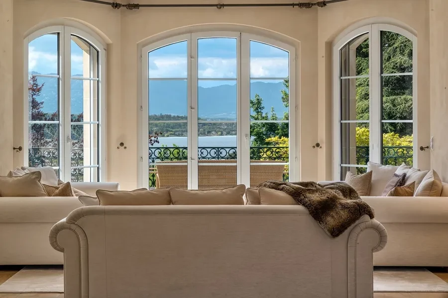 Domaine de Port-Noir Cologny Geneva — principal salon with arched windows framing panoramic views over Lake Geneva and the Alps