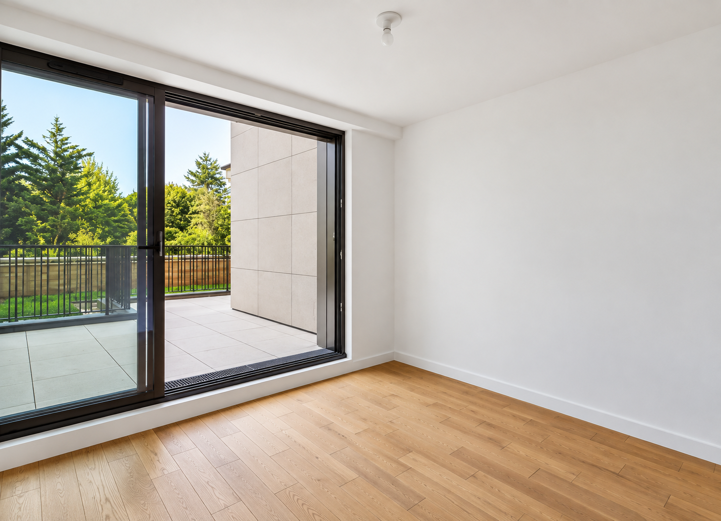 Light-filled bedroom with sliding glass doors to private terrace and garden