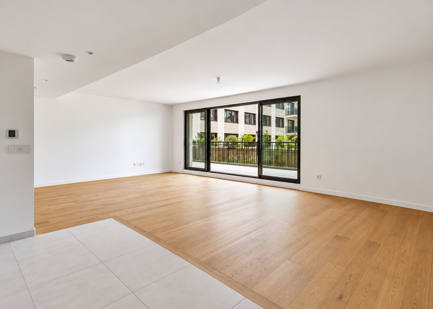 Bright open living space with large glass doors opening onto the terrace and garden