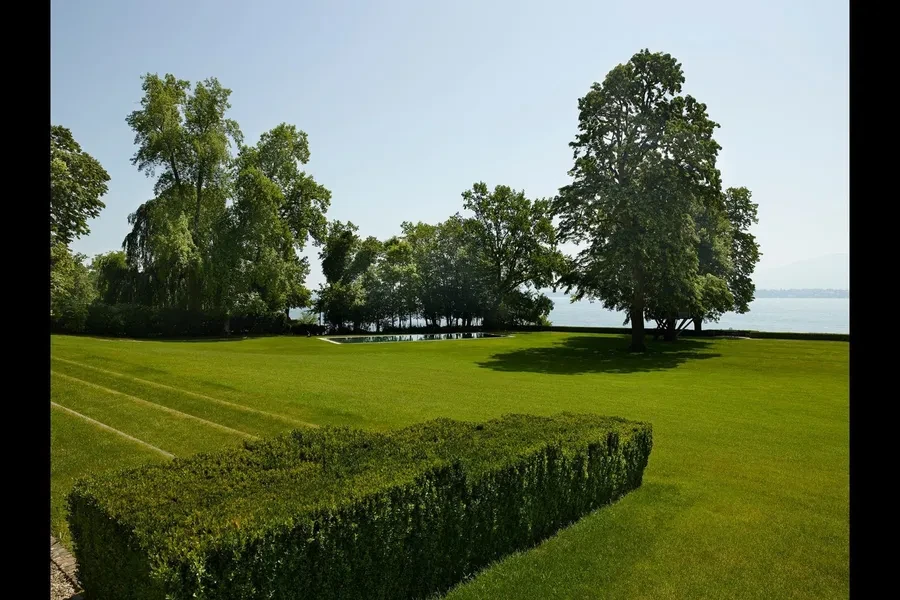 Parkland grounds with century-old trees and lake view
