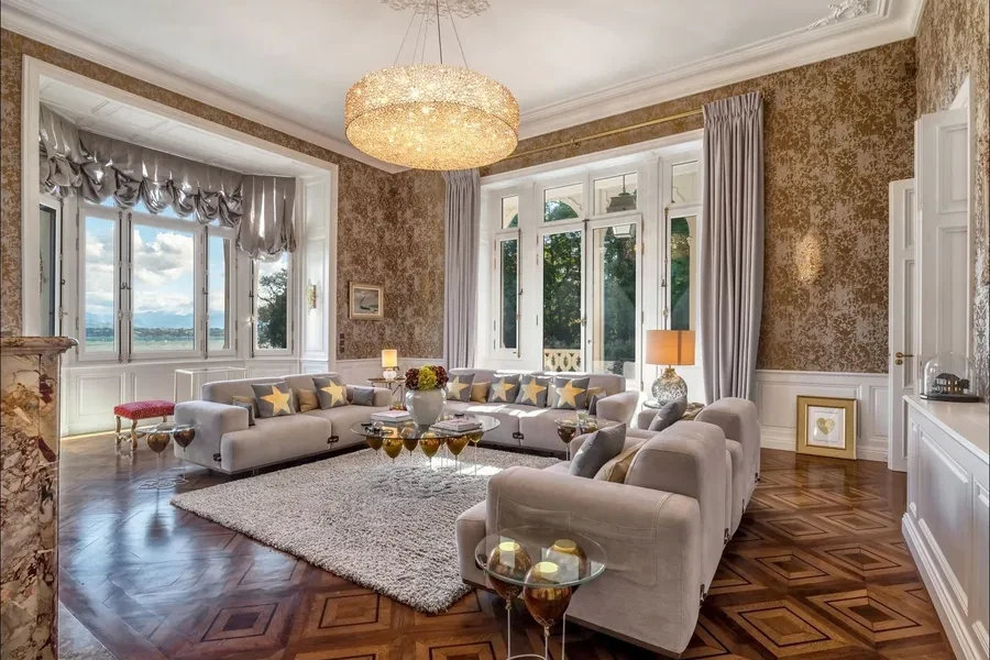 Grand salon with ornate wallpaper, parquet floors and lake views