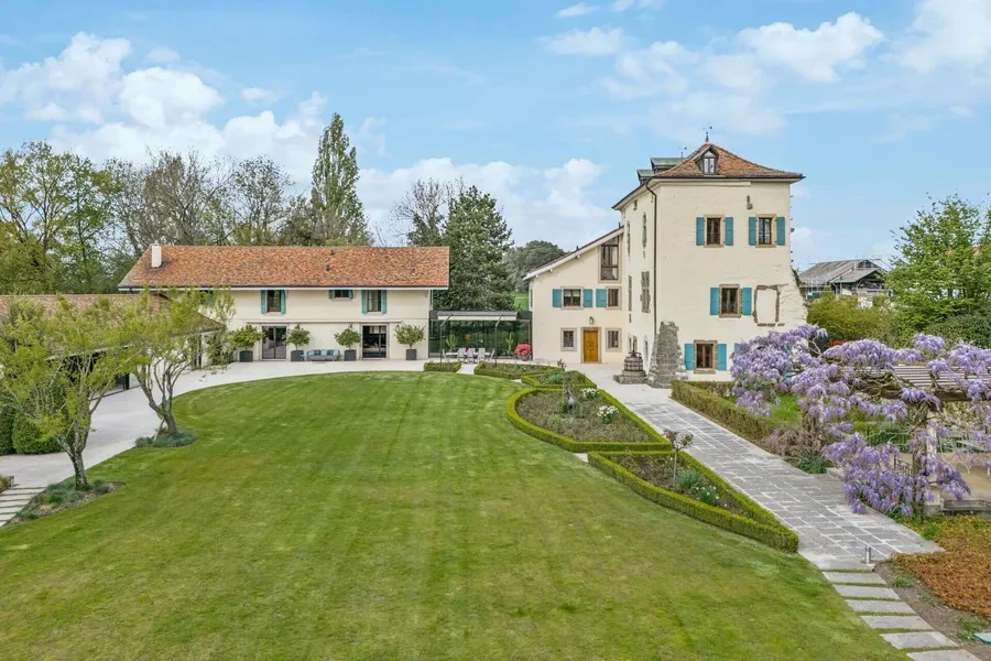 Historic château grounds with wisteria in bloom and manicured gardens