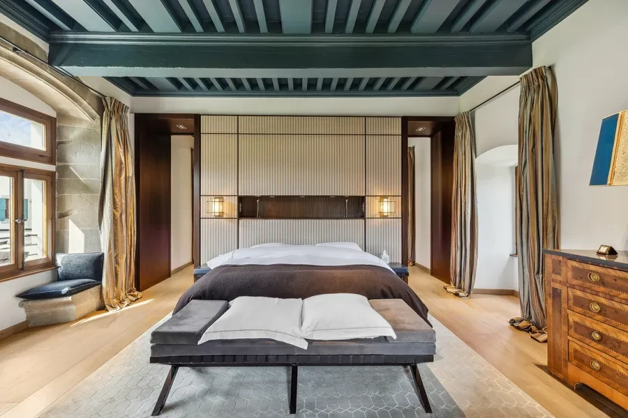 Principal bedroom suite with coffered ceiling and luxury furnishings