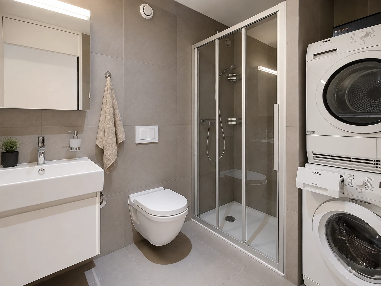 Salle de bain contemporaine avec douche et buanderie privée dans un appartement à Montreux